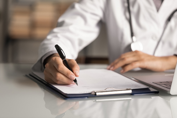 Image of a healthcare provider writing notes.